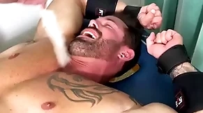 Muscular hunk endures bondage and torment on half naked body