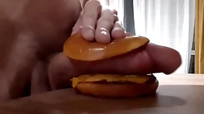Muscular sizzling teen fucks a burger with a big dick and cums in it